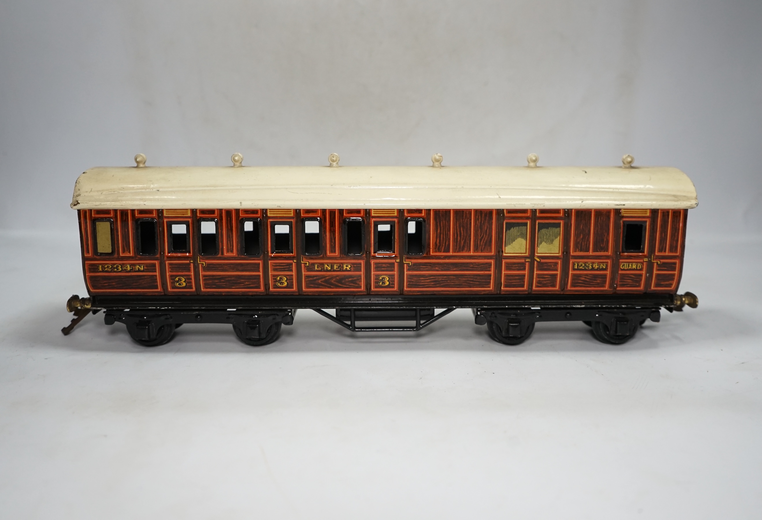 A wooden boxed Bowman Models live steam spirit fired 0 gauge 4-4-0 tender locomotive (without tender), loosely styled in black LNWR livery, together with a tinplate 0 gauge Bing for Bassett Lowke LNER teak bogie coach, 1